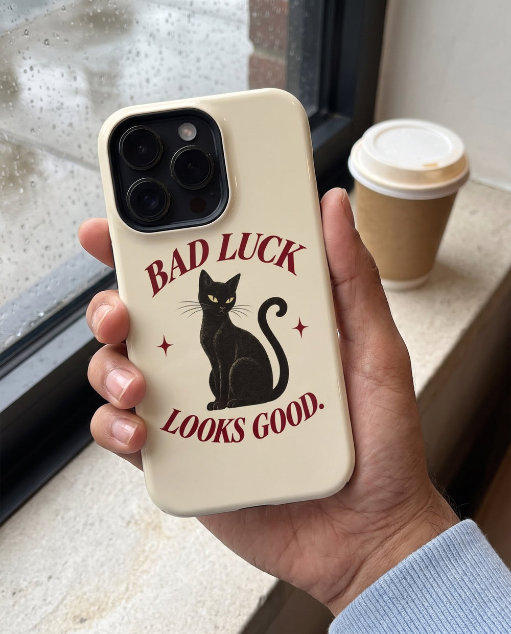 Bad Luck Looks Good iPhone case, in hand